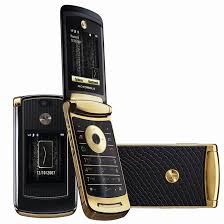 Motorola RAZR V8 shown in gold and black with flip design and dual displays.